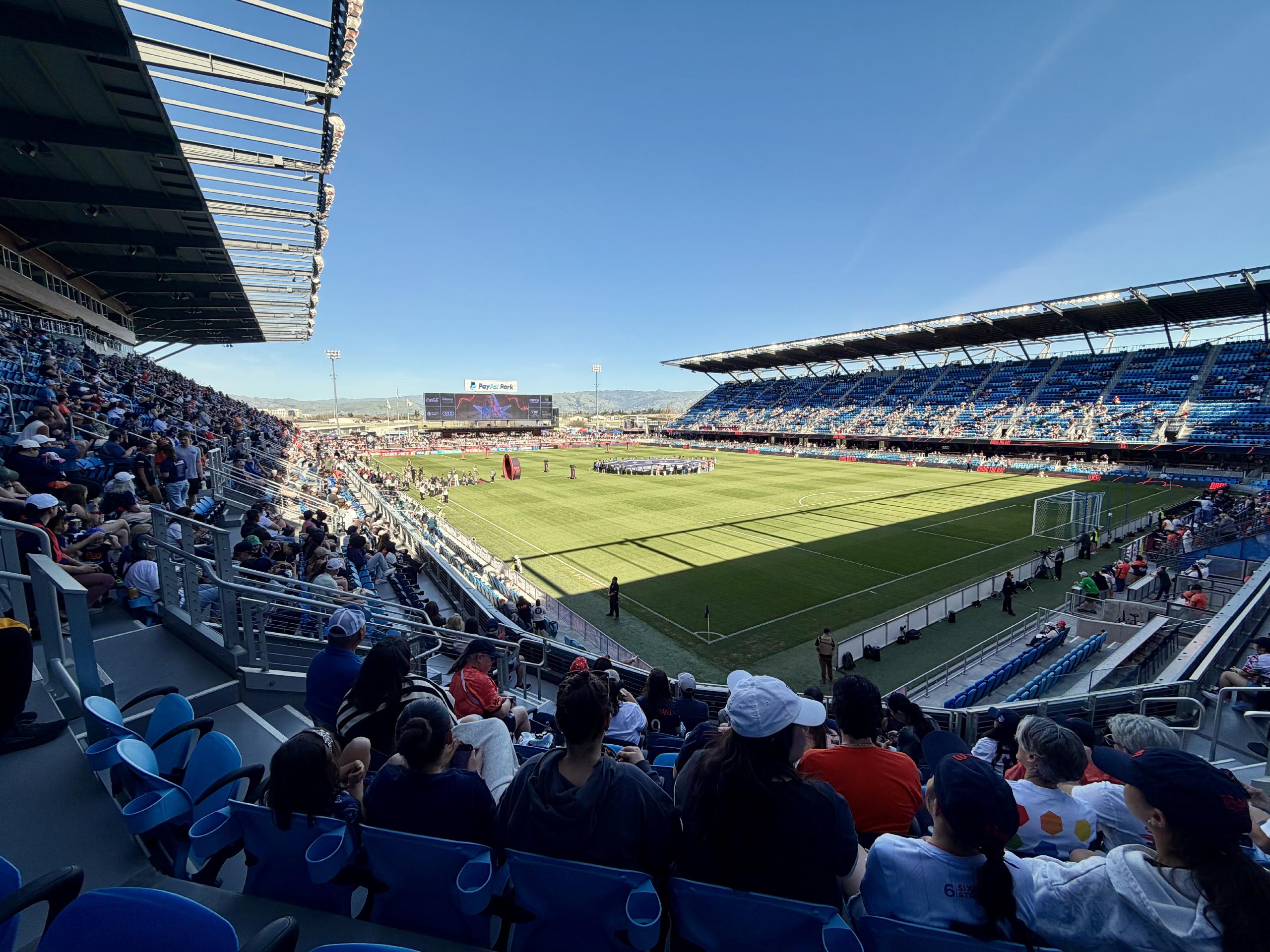 A view of the field from our seats. They were in the corner on the home side. There are people on the field holding a massive Bay FC banner. And there is a gateway set up to welcome the team onto the field.
