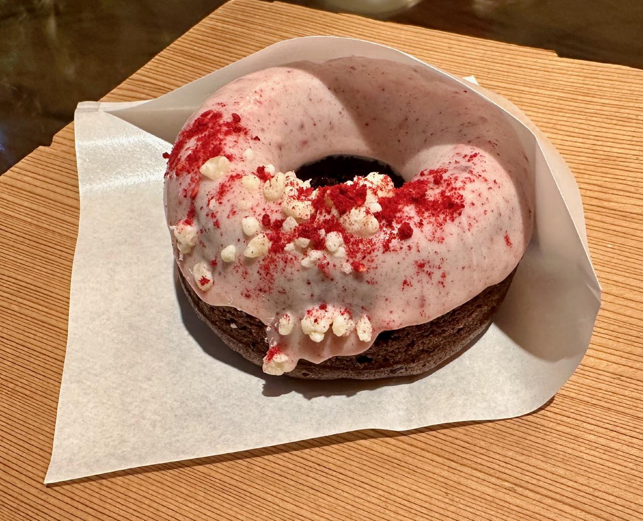 A chocolate and raspberry donut at Hocus Pocus